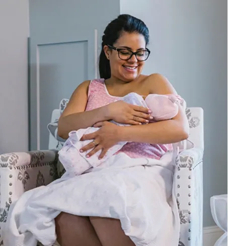 A mother breastfeeding at home