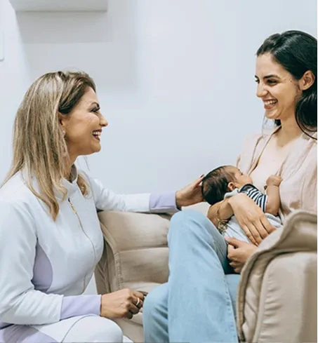 A practitioner supporting a mother to breastfeed